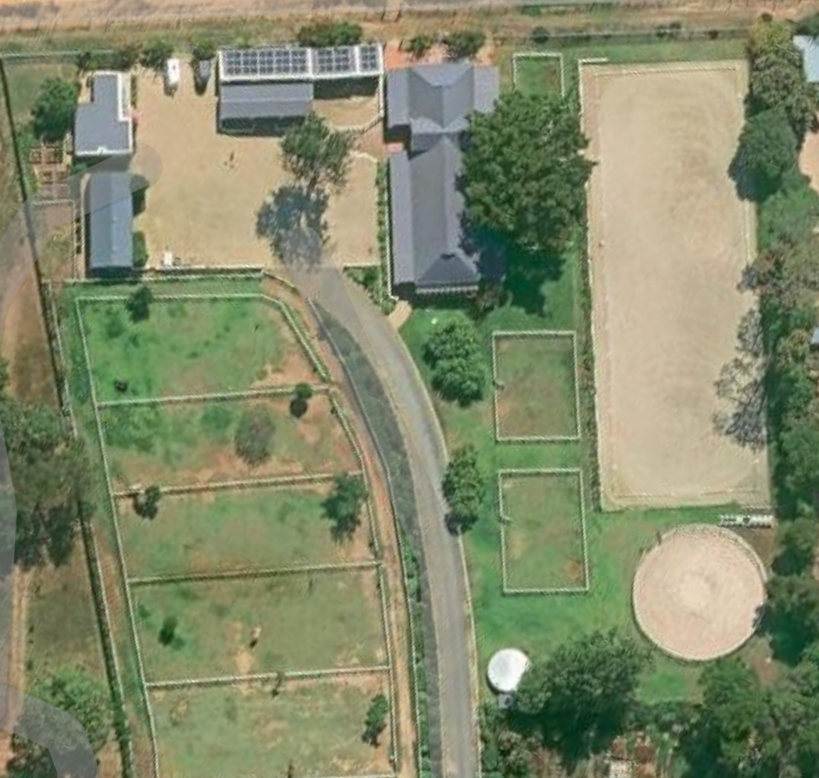 Aerial view of Bentgrass Stables showing solar panels on rooftops and the complete facility layout