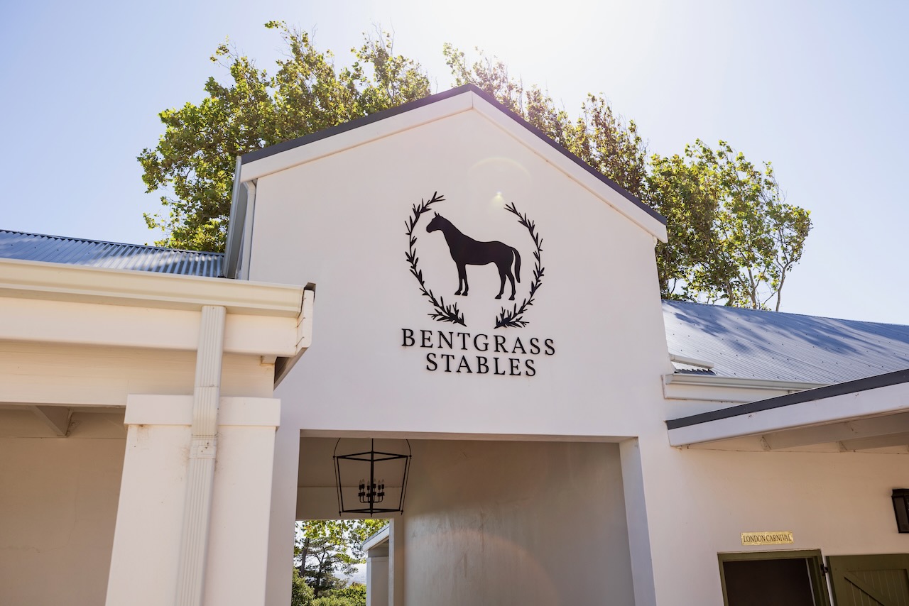 Close-up of Bentgrass Stables logo and branding on main building facade