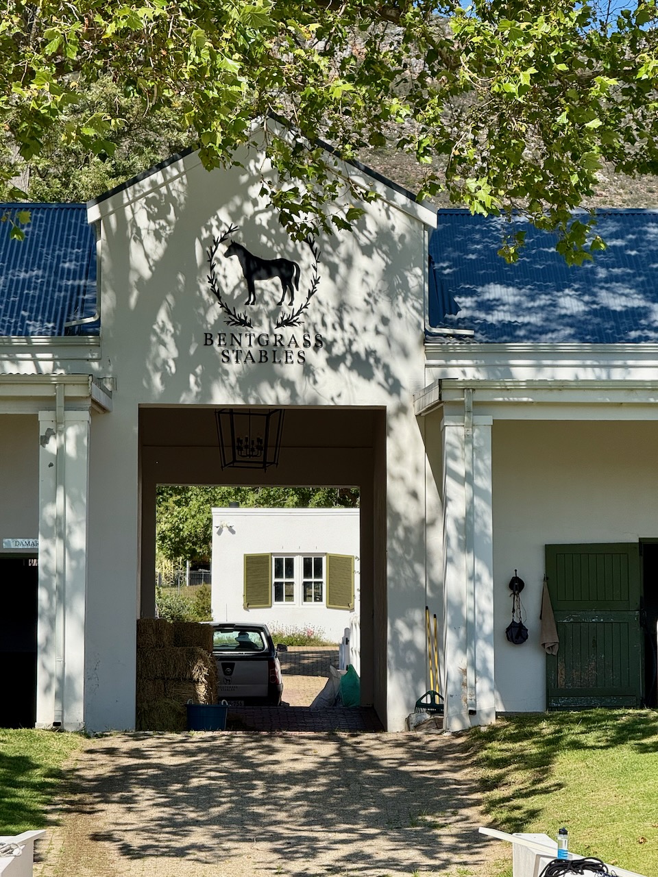 Main entrance archway of Bentgrass Stables with logo and solar panels visible